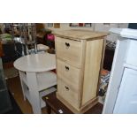 A wooden chest fitted three drawers