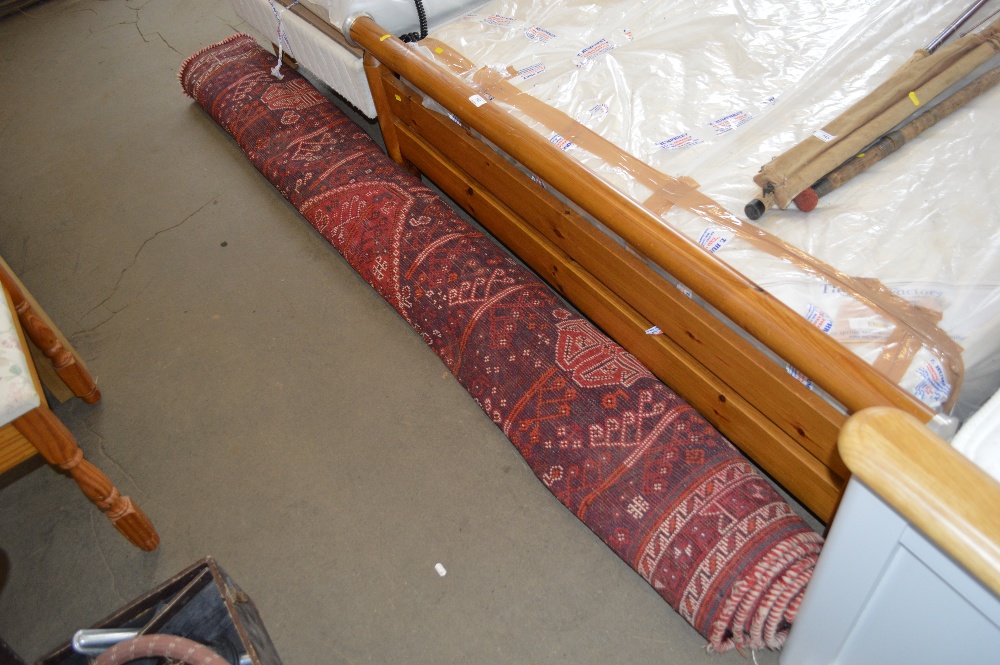 An approx 10'1" x 7'8" red patterned carpet