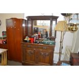 An oak mirrored back sideboard fitted two drawers