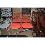A set of four metal red painted chairs