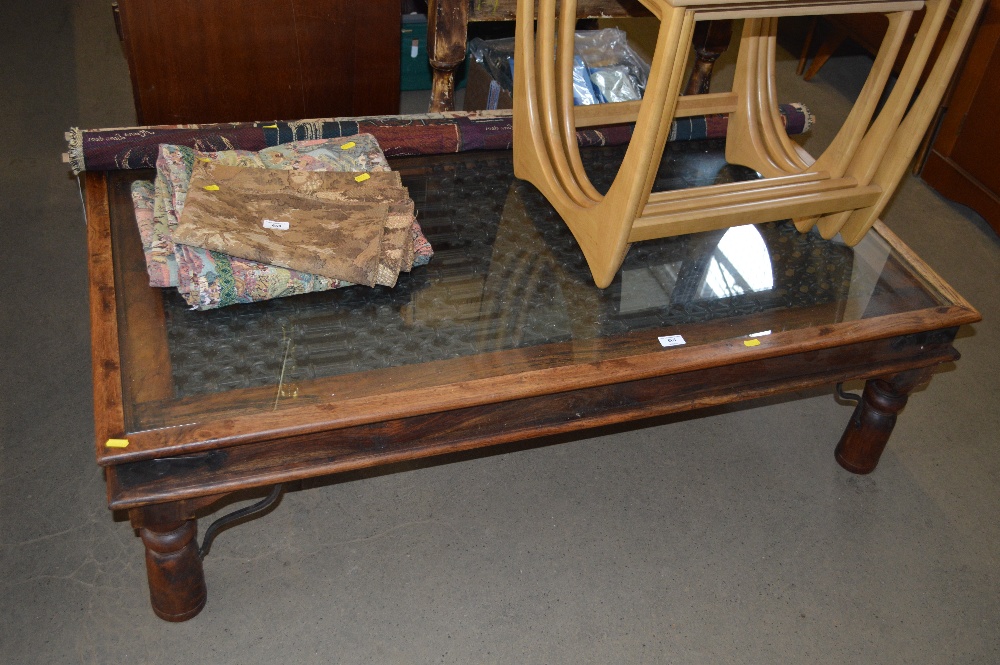 A hardwood coffee table with glass inset