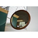 An oval bevel edge wall mirror