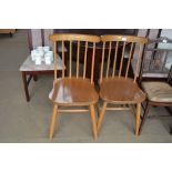 A pair of beech spindle back dining chairs