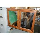 A pine mirror fronted bathroom cabinet