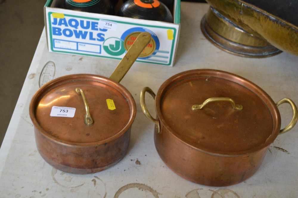 A copper saucepan and lid together with a copper c