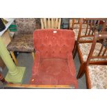 A red upholstered button back nursing chair