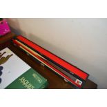 A two piece snooker cue in fitted case