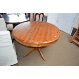 A pine circular topped extending dining table