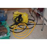 A small Karcher pressure washer