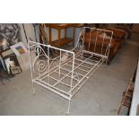 An ornate metal day bed frame