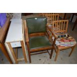 An oak elbow chair; and a set of four rail back light wood kitchen chairs