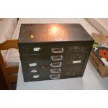 A small metal five drawer chest and contents