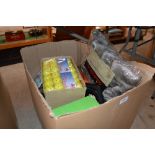 A box containing various golf balls; golf club cov