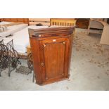 A 19th Century oak inlaid corner cupboard