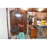 A 1930's oak wardrobe; and similar dressing table