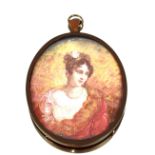 A miniature portrait on ivory, of a young woman and an amber and silver mounted dress ring