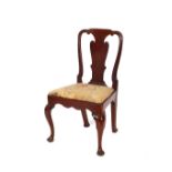 A set of four George I walnut dining chairs, having vase splat backs, drop in seats raised on