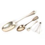 A George III silver spoon, 1814; a George III pair of silver miniature tongs, London 1813; and a