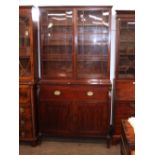 A George III mahogany secretaire bookcase, the writing drawer flanked by Egyptianesque columns