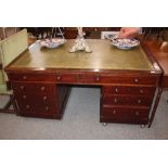 A large Victorian mahogany pedestal writing desk, the green leatherette inset top above four long