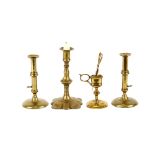 A pair of antique brass slide action candlesticks, raised on circular bases 17cm high; an antique