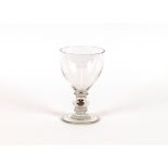 An Antique glass rummer, the baluster shaped stem inset with a silver coin on circular spread
