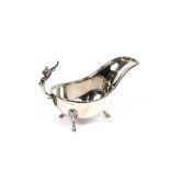 An ornate silver plated sauce boat, having Phoenix handle, raised on hoof feet with beaded border