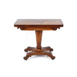 An early 19th Century oak foldover card table, raised on octagonal column and quatrefoil base,