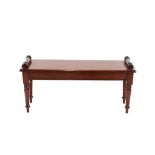 A pair of Regency style mahogany window seats, with turned scroll ends, raised on ring turned