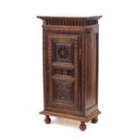 An 18th Century oak and elm food cupboard, of narrow proportions, having turned spindle decoration