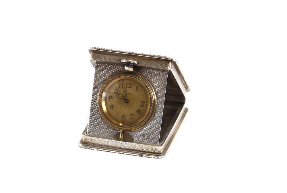 A silver cased travelling watch holder, with engine turned decoration and monogram, containing a - Image 2 of 2