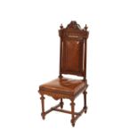 A pair of late Victorian carved oak hall chairs, having leather upholstered back panels and seats,
