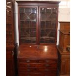 A George III mahogany bureau bookcase, the upper adjustable shelves enclosed by a pair of glazed
