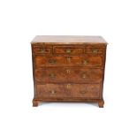 An Antique walnut and cross-banded chest, fitted three short and three long drawers within reeded