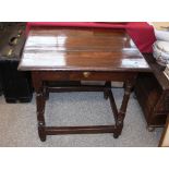 An 18th Century fruit wood side table, fitted with a single drawer raised on turned baluster