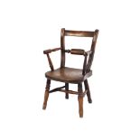 A 19th Century elm child's paddle back elbow chair, the solid seat raised on ring turned tapering