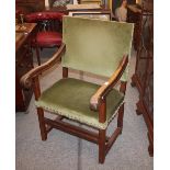 An 18th Century continental walnut elbow chair, with green Dralon upholstered seat and back,