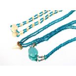 A turquoise and shark's tooth set ethnic necklace; and one other