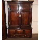 An 18th Century oak two door hanging cupboard, enclosed by fielded panels, two drawers to the