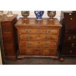 A Georgian walnut and cross-banded chest, of small proportions, fitted four long graduated drawers