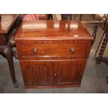A Victorian mahogany ships washstand, with fold over top and cupboards below, raised on a platform