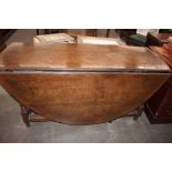 A large 18th Century oak gate leg dining table, fitted with a single end drawer, the rounded