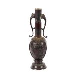 A Japanese bronze vase, of baluster form with raised decoration and scrolled beast handles,