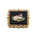 A fine quality micro Mosaic brooch, depicting a recumbent spaniel in yellow metal scrolled frame