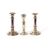 A silver candlestick, Birmingham 1919; and a pair of plated candlesticks with gadroon bordered