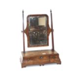 An Antique walnut swing toilet mirror, raised on a three drawer box base, supported on bracket feet,