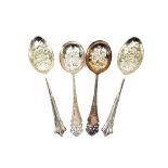A pair of late Victorian silver serving spoons, having shaped pierced terminals and floral