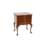 A walnut and cross-banded serpentine fronted chest, of small proportions, fitted three graduated