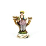 A 19th Century continental porcelain figural decorated twin branch candle holder, in the form of a