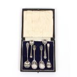 A case containing six various silver condiment spoons
